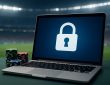 A laptop displaying a lock symbol with casino chips beside it in a sports stadium setting.